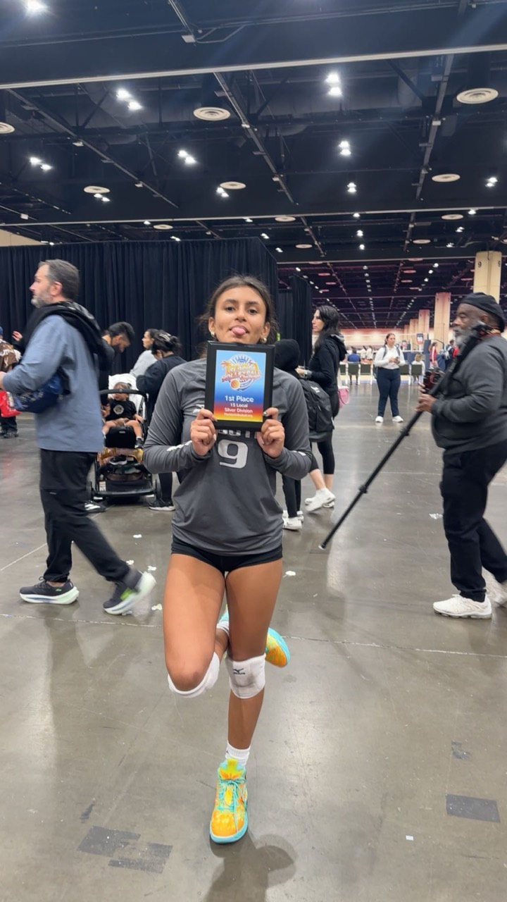 Fabi holding her first-place volleyball award after a tournament
